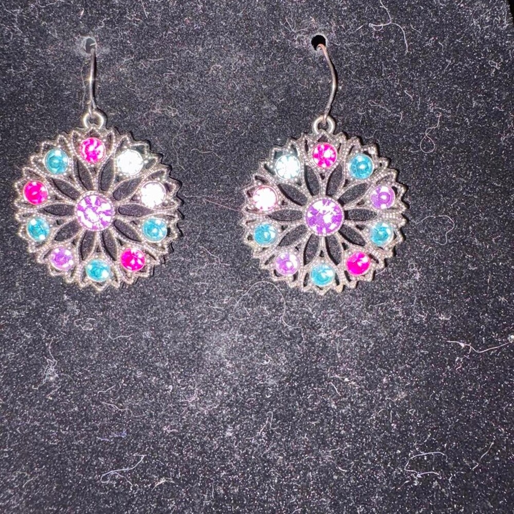 Black toned metal earrings with pink, blue, and white rhinestones arranged in a